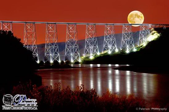 Lethbridge High Level Bridge lit at night looking down the Oldman river with a full moon from Paterson Photography fine art