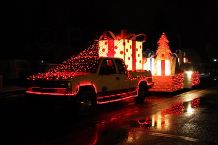 A parade float at night lite up with Christmas lights at the Parade of lights in Coaldale