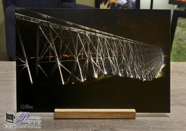 Picture stand with a printed and mounted print of the Lethbridge High Level bridge lit up at night